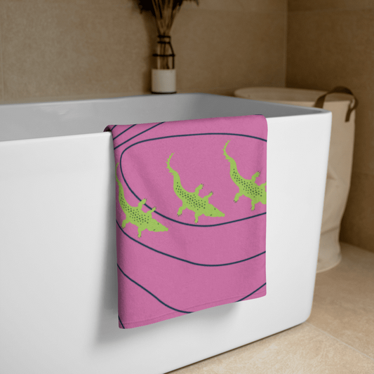 Pink towel with green crocodiles